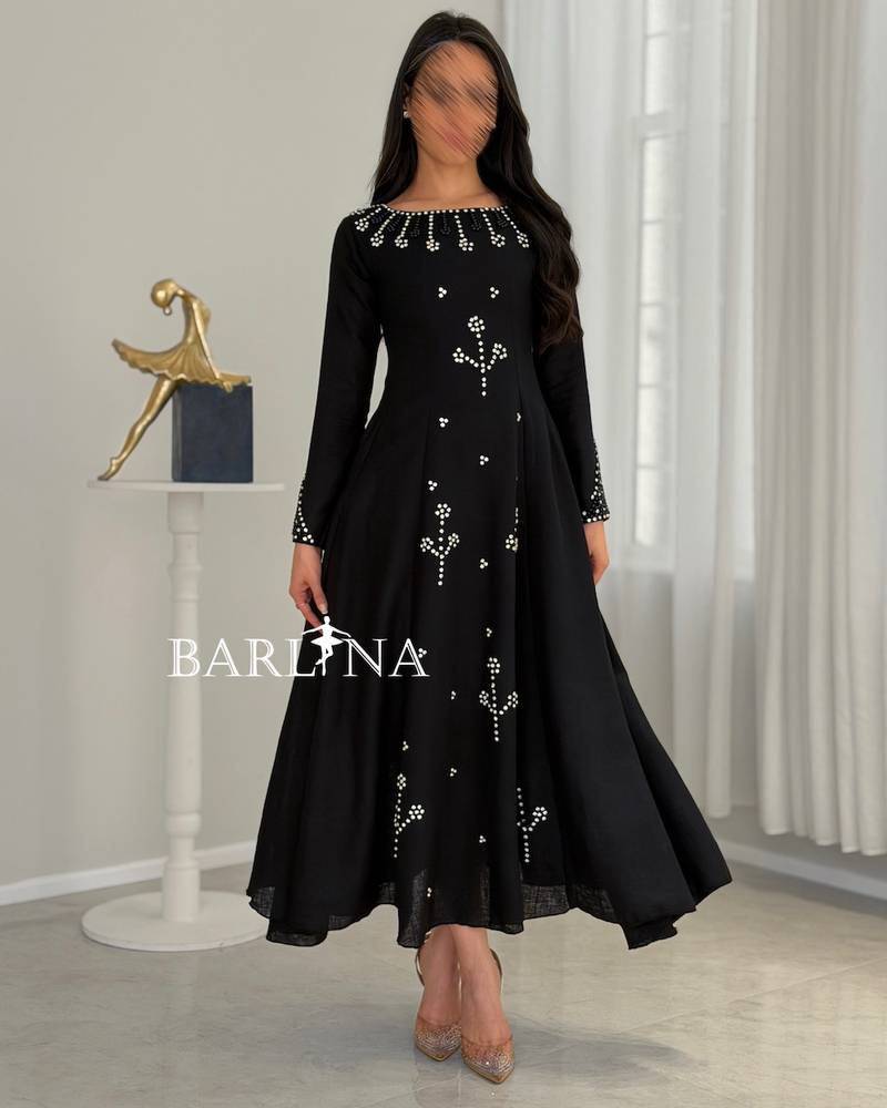 Black flared dress with pearl and crystal embellishments