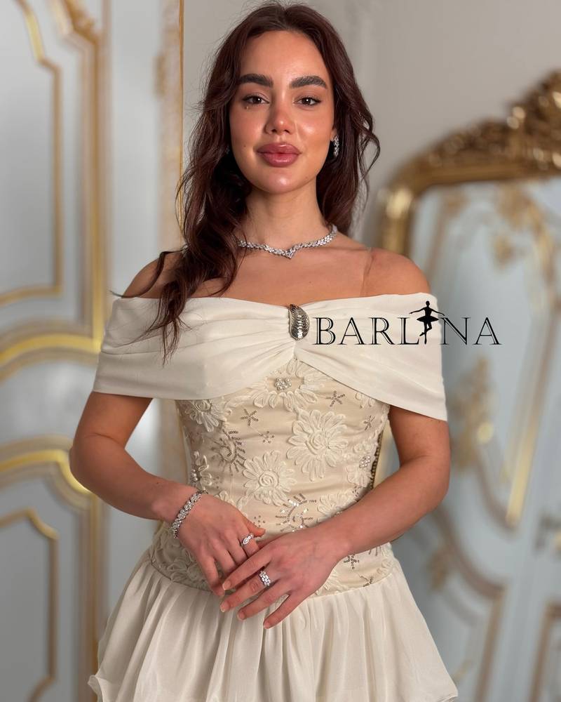 Ivory layered dress with an off-the-shoulder neckline