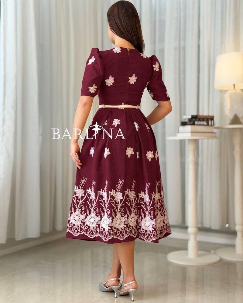 Burgundy midi dress adorned with white embroidery