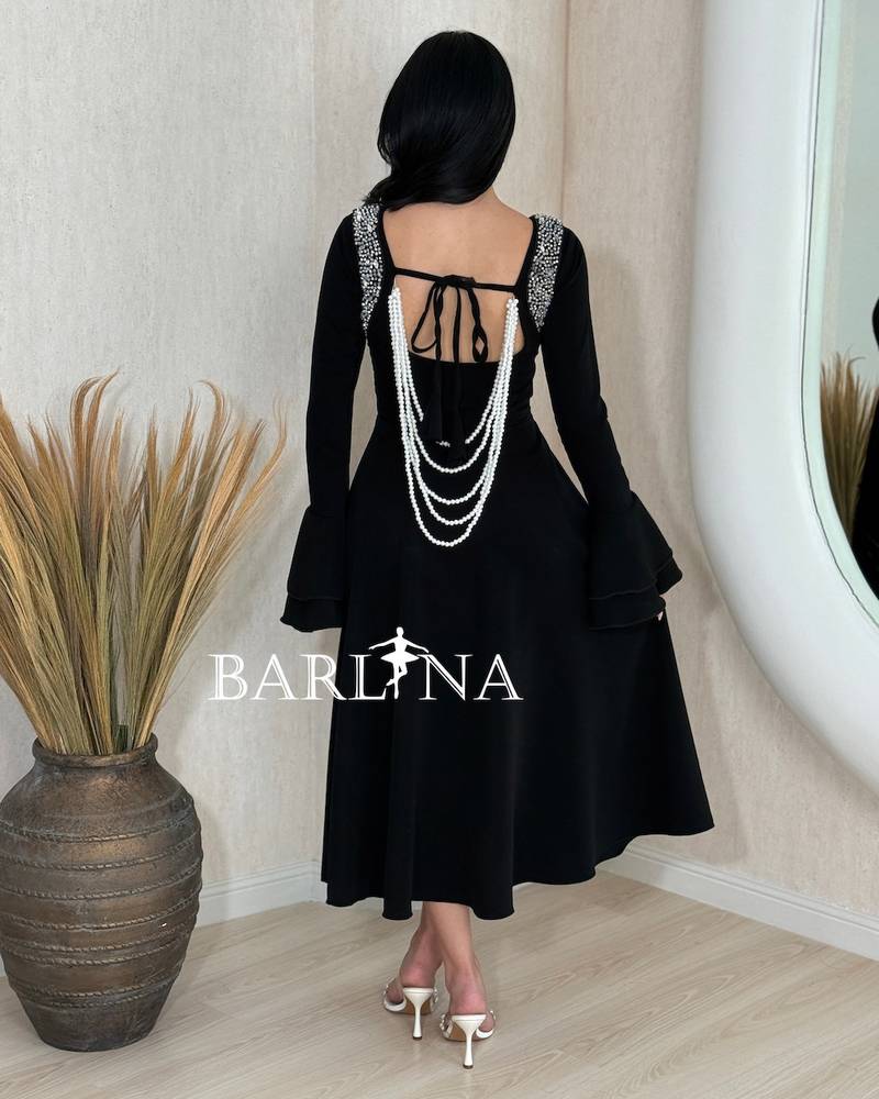 A soft black dress with a crystal-embellished collar.