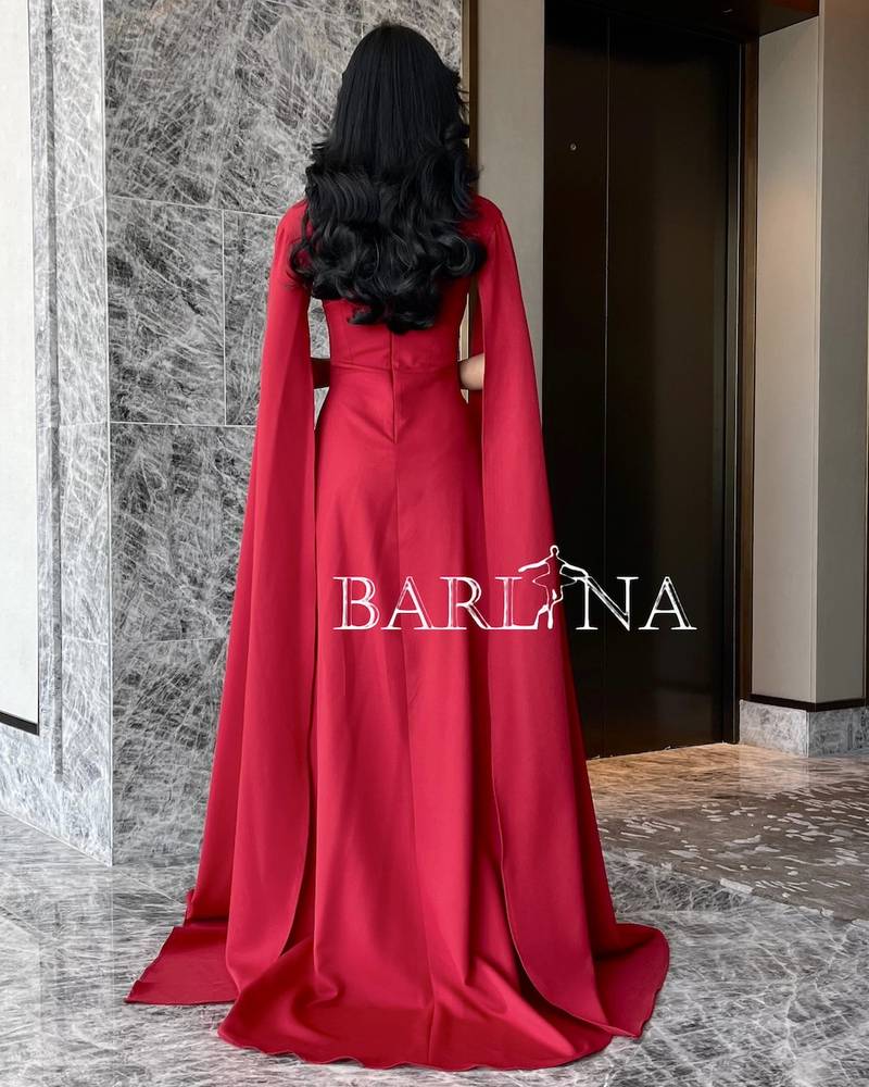 Soft red dress with long cape sleeves