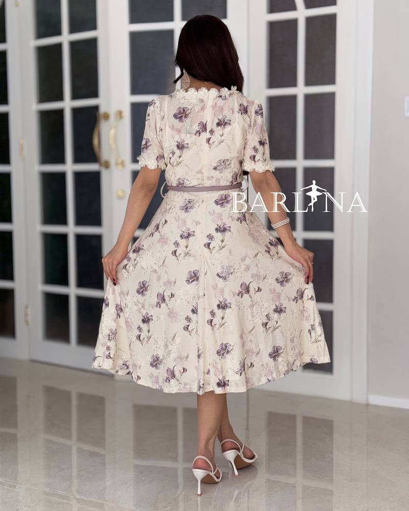 A soft dress adorned with a lace collar and sleeves