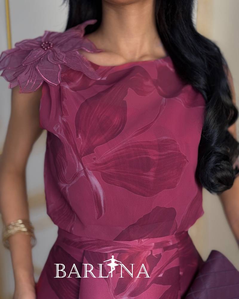 Elegant fuchsia dress with a prominent rose on the shoulder
