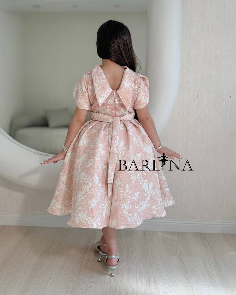 Pink girls' dress decorated with roses