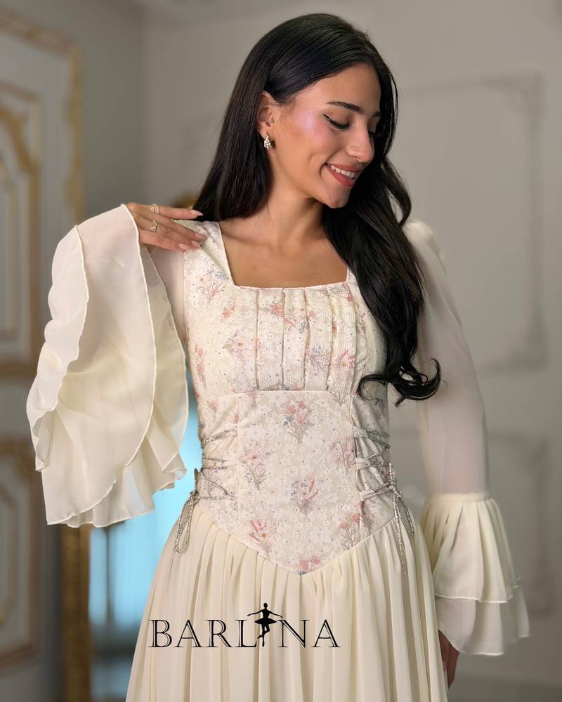 Off-white dress with an embroidered bodice and bell sleeves