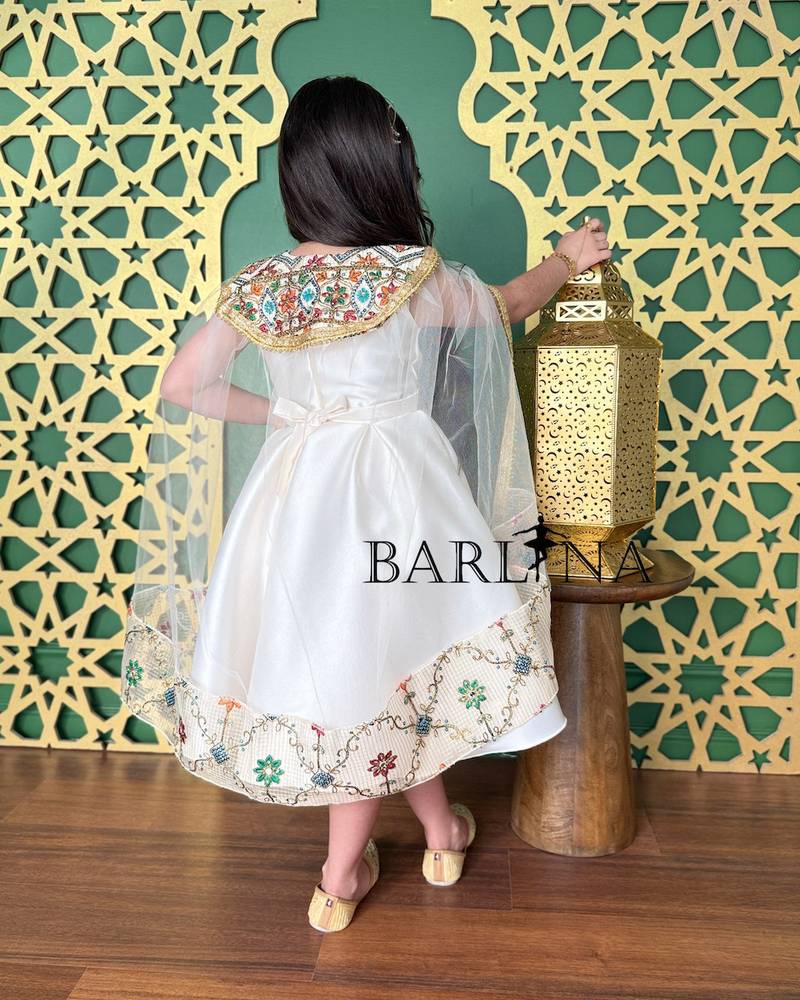 Off-white girls' dress decorated with oriental embroidery