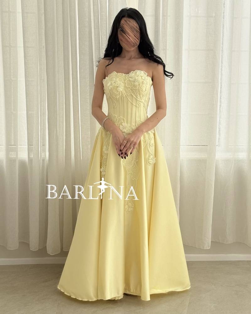 Light yellow evening dress with an embroidered corset cut