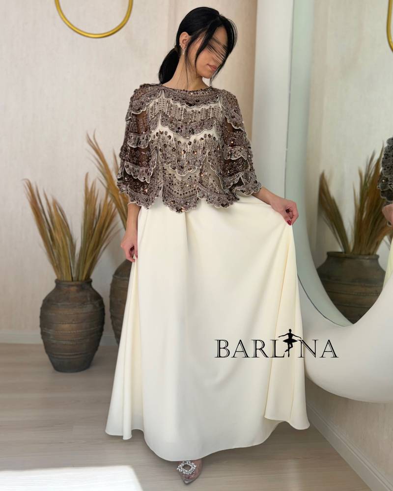 Elegant off-white dress with an embroidered overlay