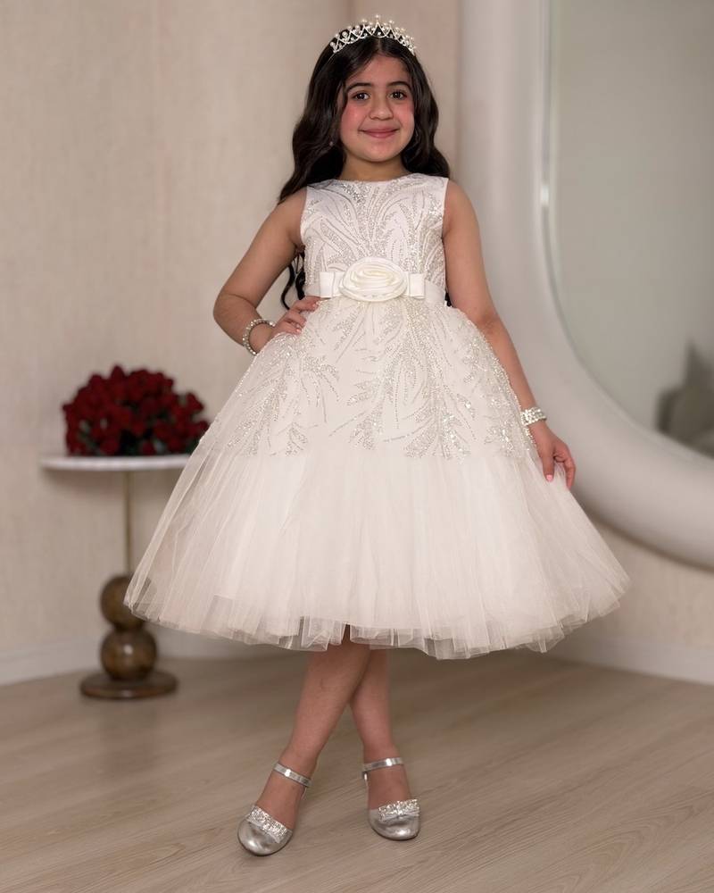 White girl's dress decorated with glitter patterns and a belt