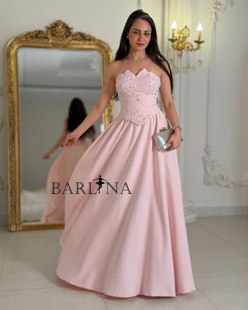 Pink sleeveless evening dress decorated with roses