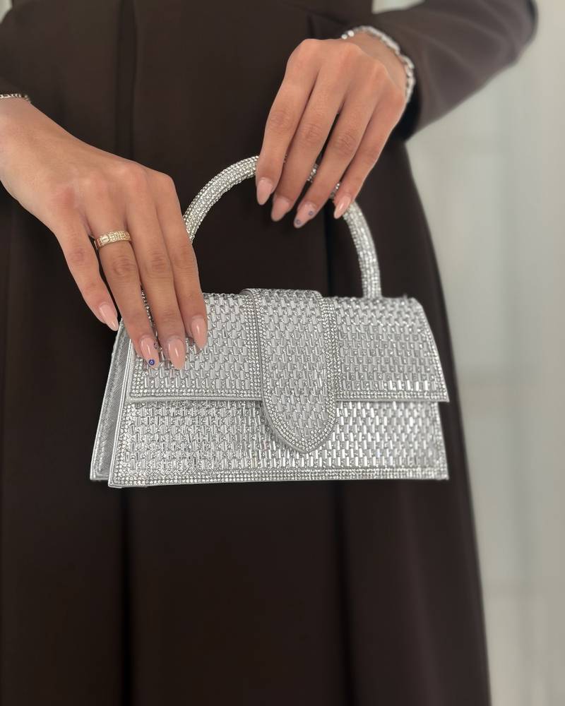 An evening bag completely covered in crystal studs