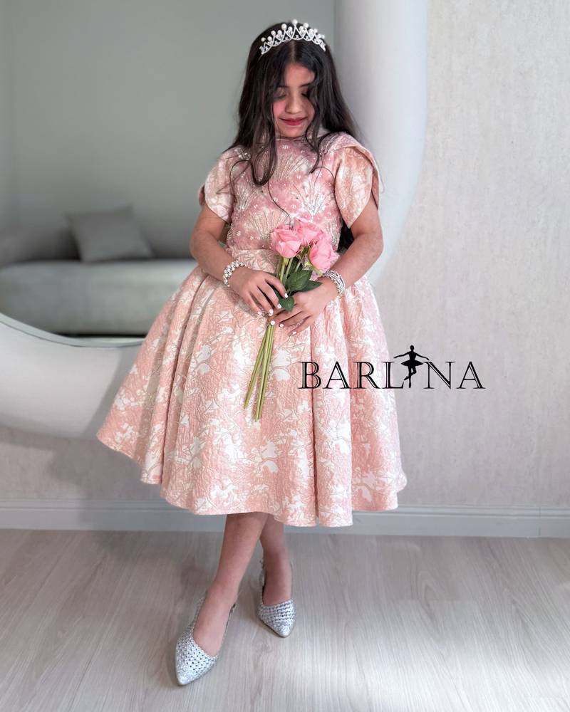 Pink girls' dress decorated with roses