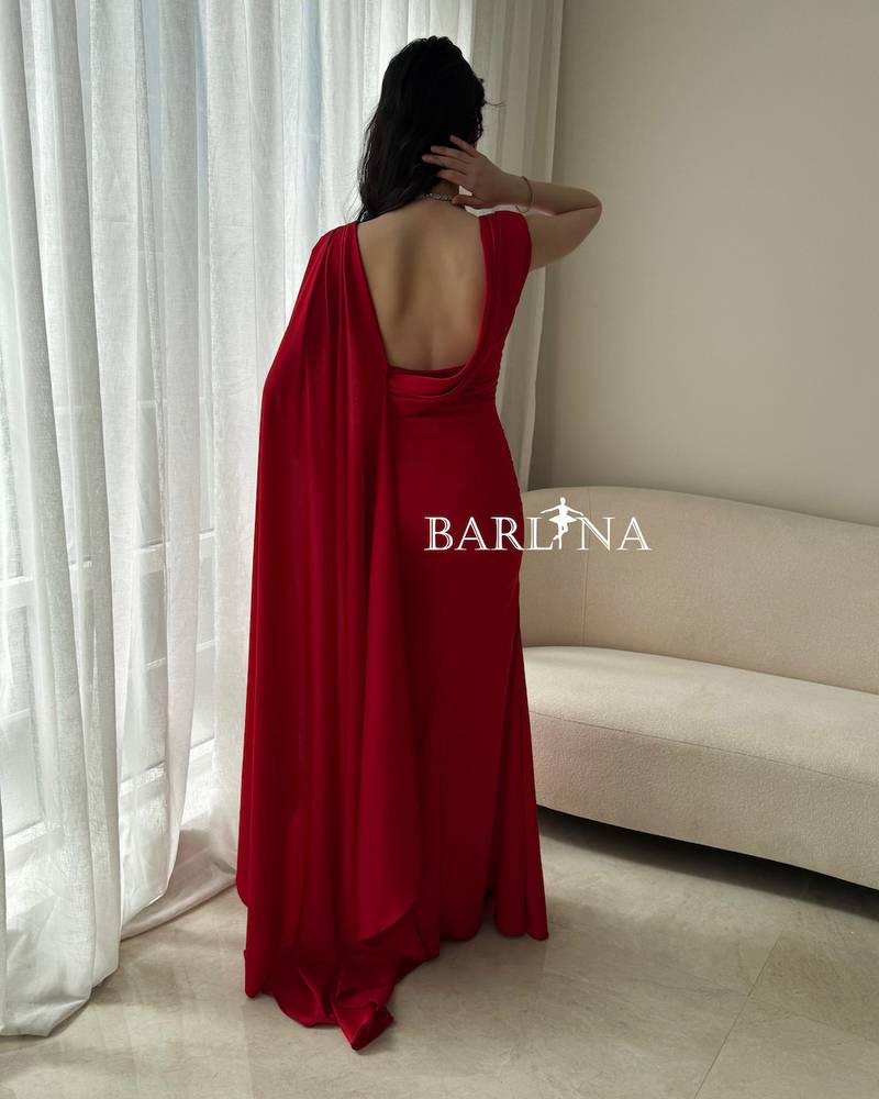 Red dress with a side cape and soft pleats