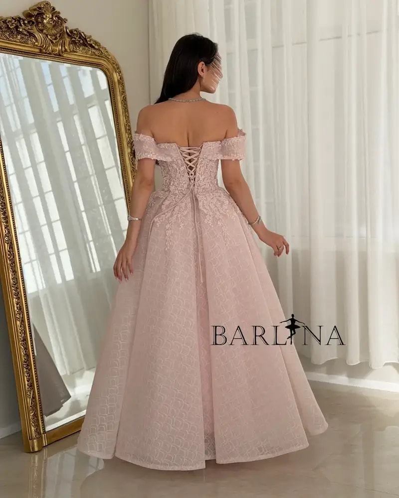 A pink puffy evening dress adorned with delicate embroidery