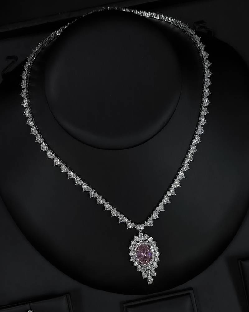 A luxurious accessory set adorned with an elegant pink stone.