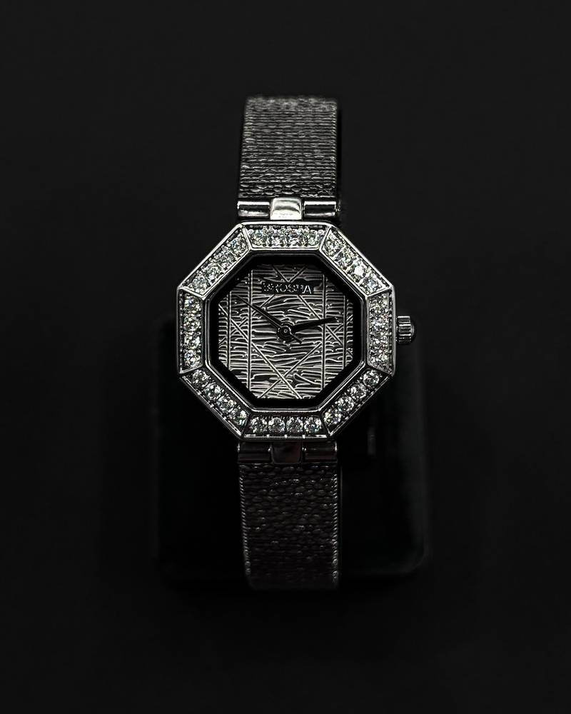 An octagonal bezel wristwatch studded with gemstones