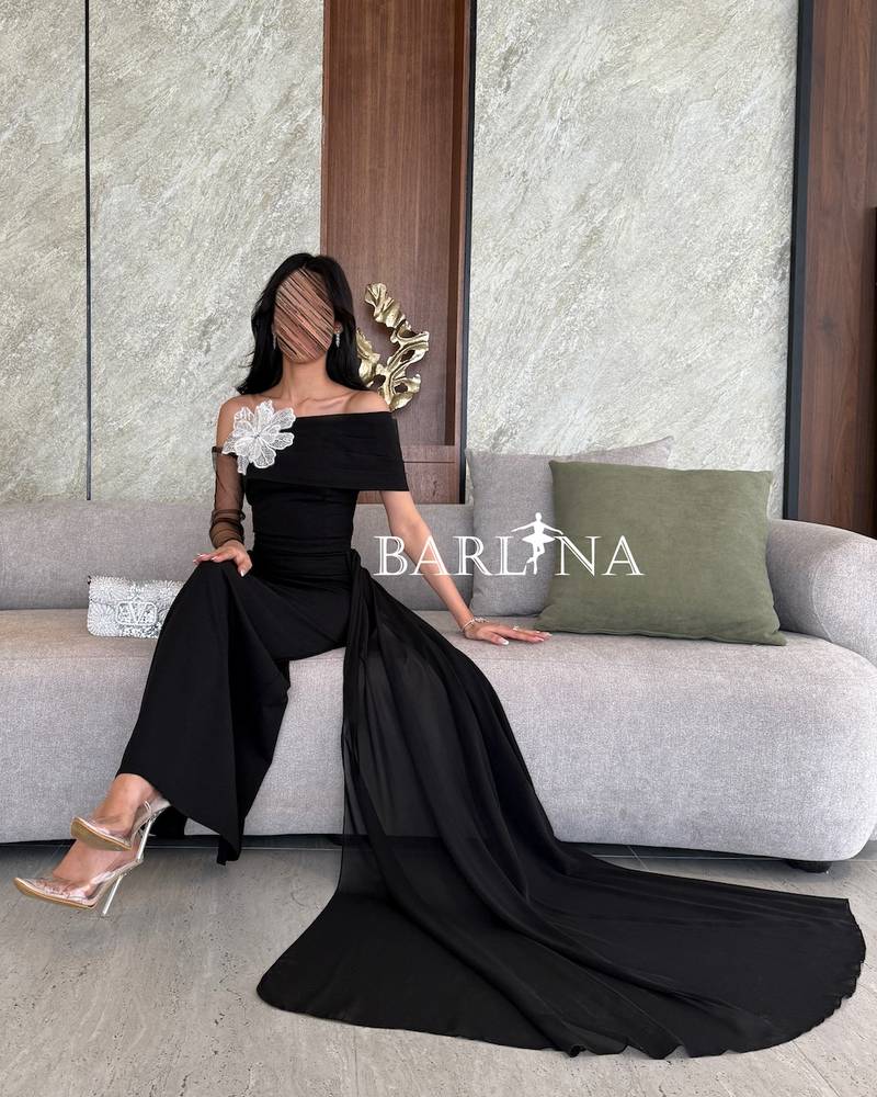 Black off-shoulder dress with a light side train