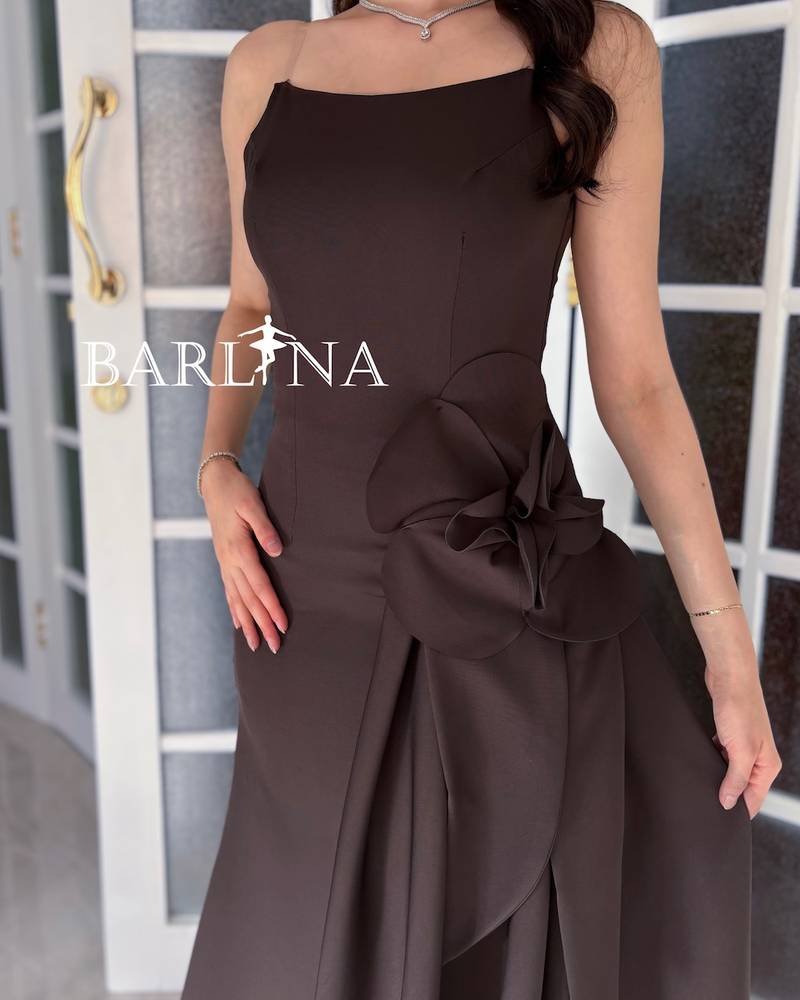 A brown dress with an elegant design and a flowing train