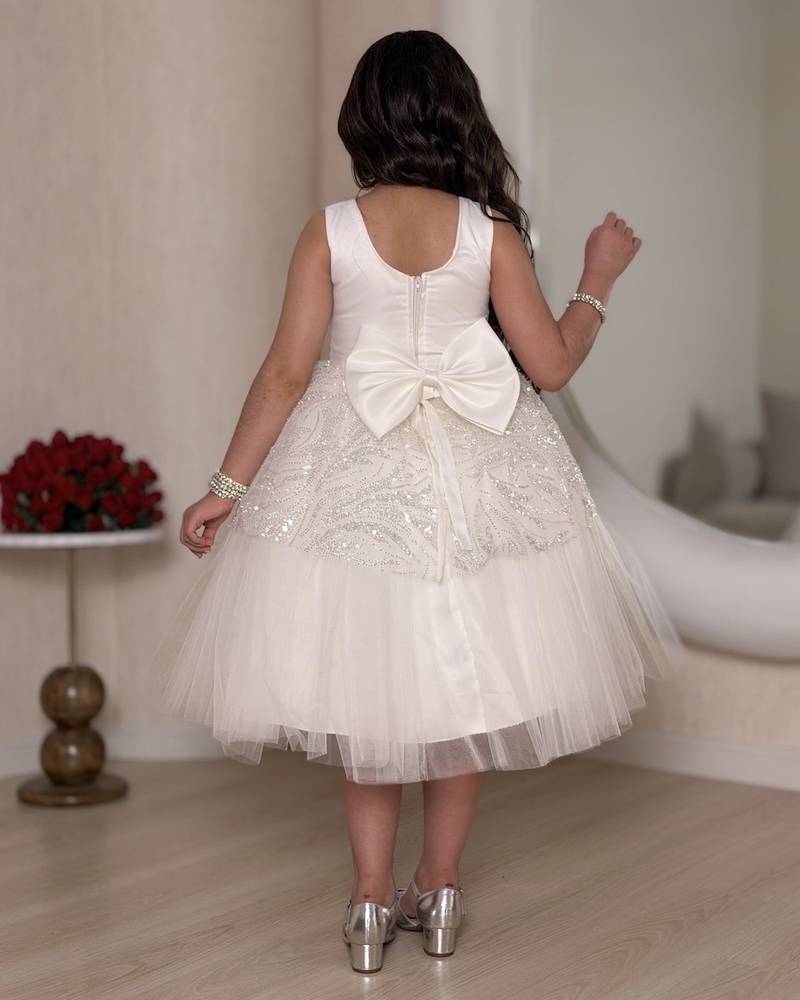 White girl's dress decorated with glitter patterns and a belt