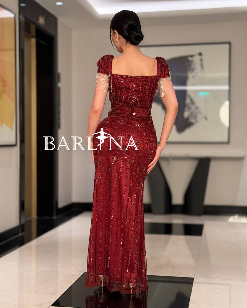 A burgundy dress fully embroidered with sparkling details