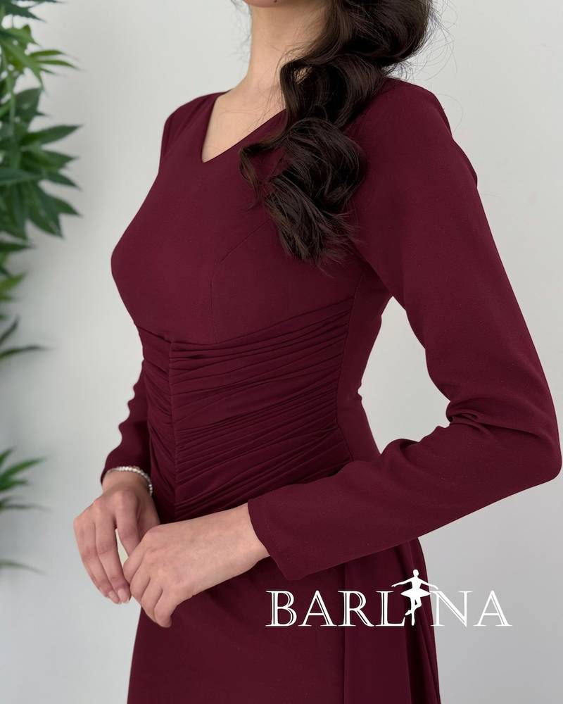 Dark burgundy dress with a gathered hem and a light train