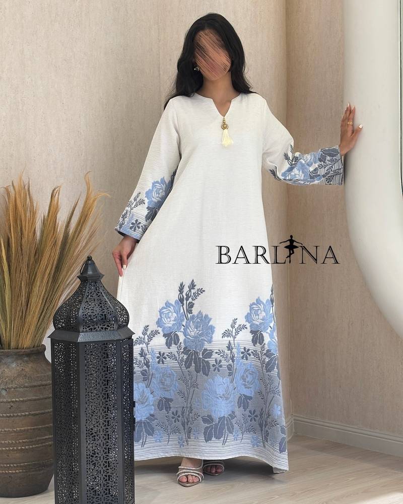 White jalabiya with a blue floral pattern