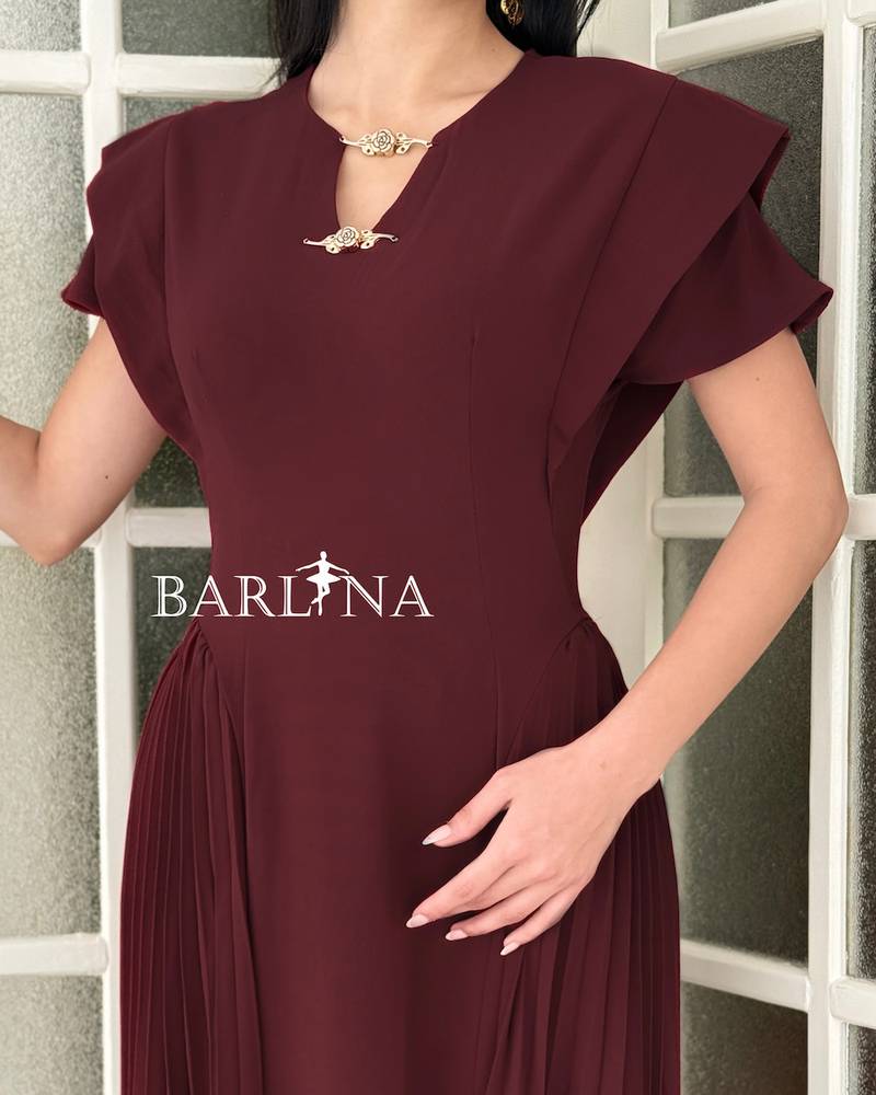 A soft burgundy dress with side pleat details
