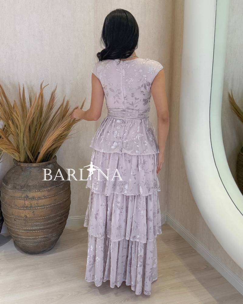 Light mauve dress with a layered cut and embellished fabric