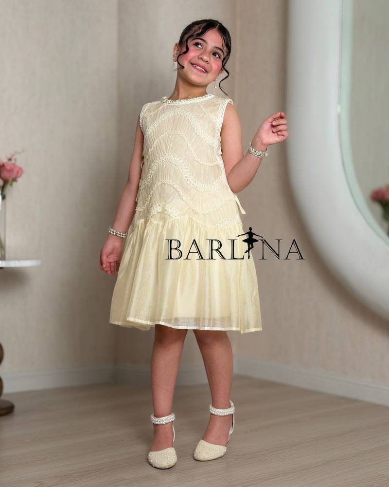 Girls dress in a soft cream color