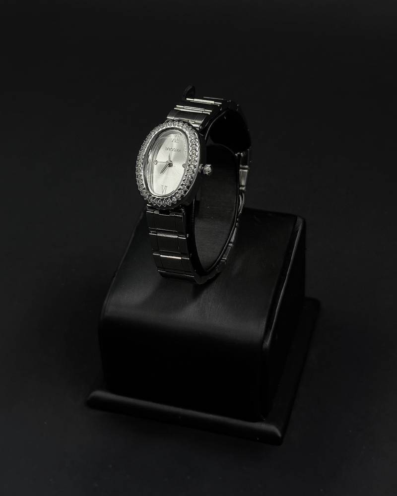 An oval-shaped watch surrounded by crystal