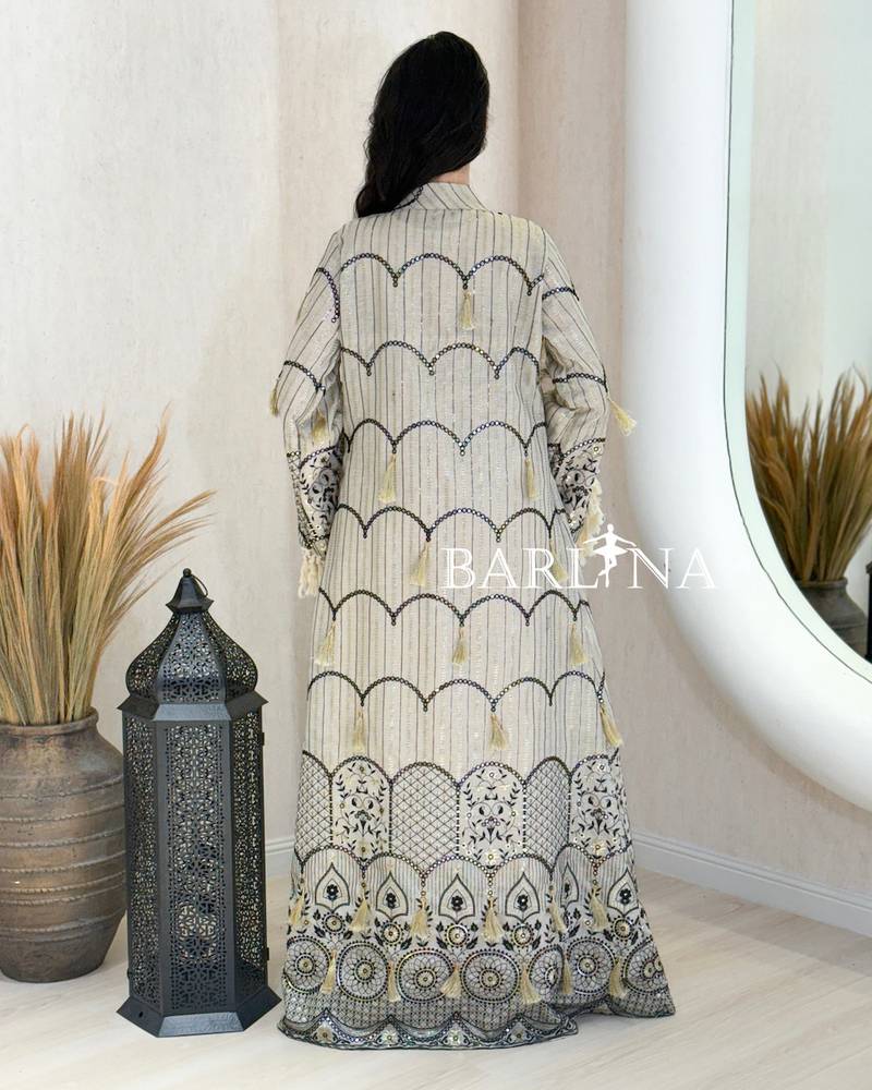 A jalabiya with a geometric pattern in shades of beige and black.