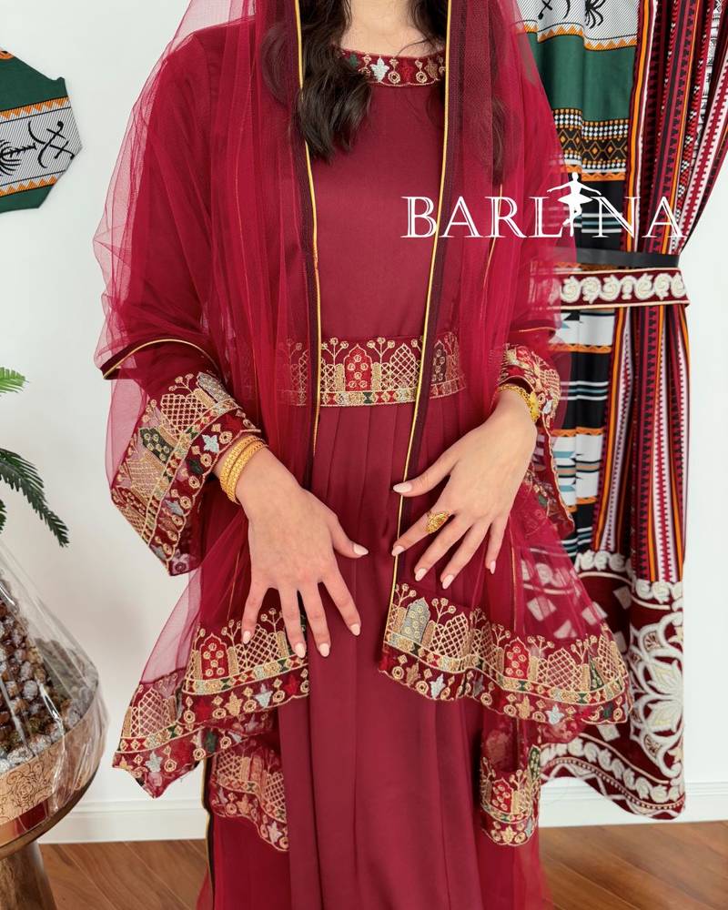 Maroon jalabiya decorated with colorful embroidery
