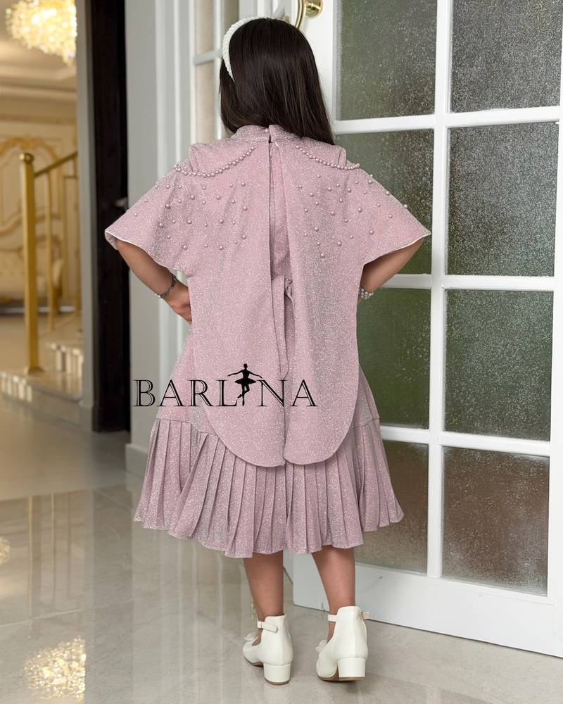 A shiny dress with a straight cut and a ruffled hem.