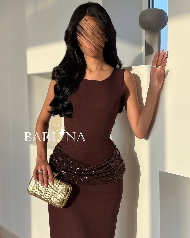 Long brown dress with shiny embroidery around the waist
