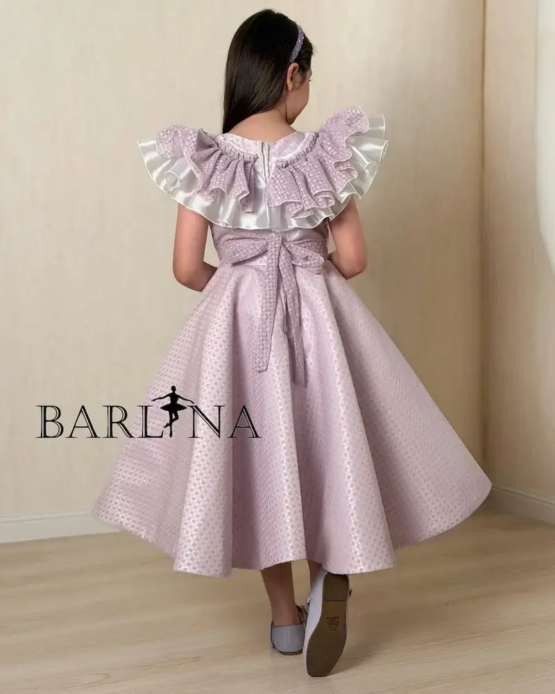 Purple girl's dress decorated with a large bow