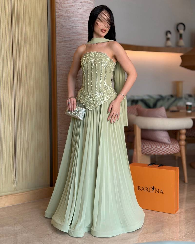 Light green evening dress with a pleated hem