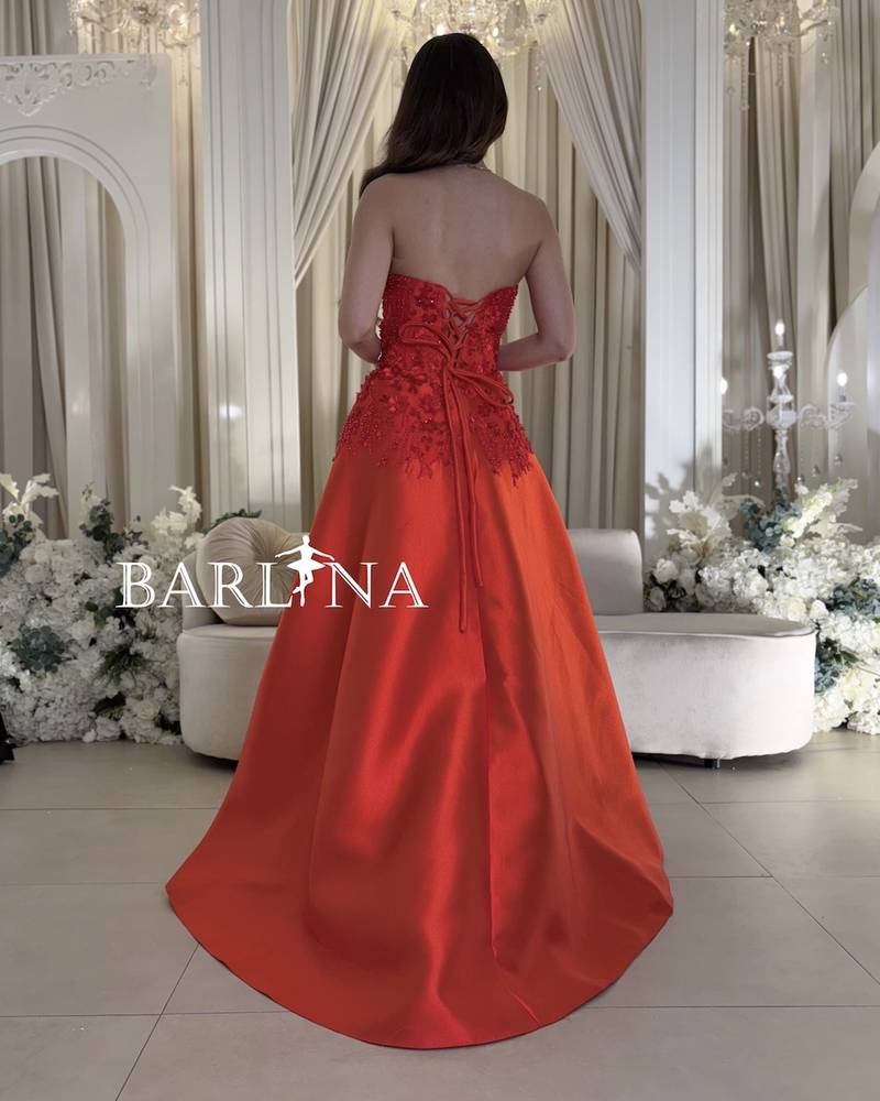 Red sleeveless dress with prominent floral patterns