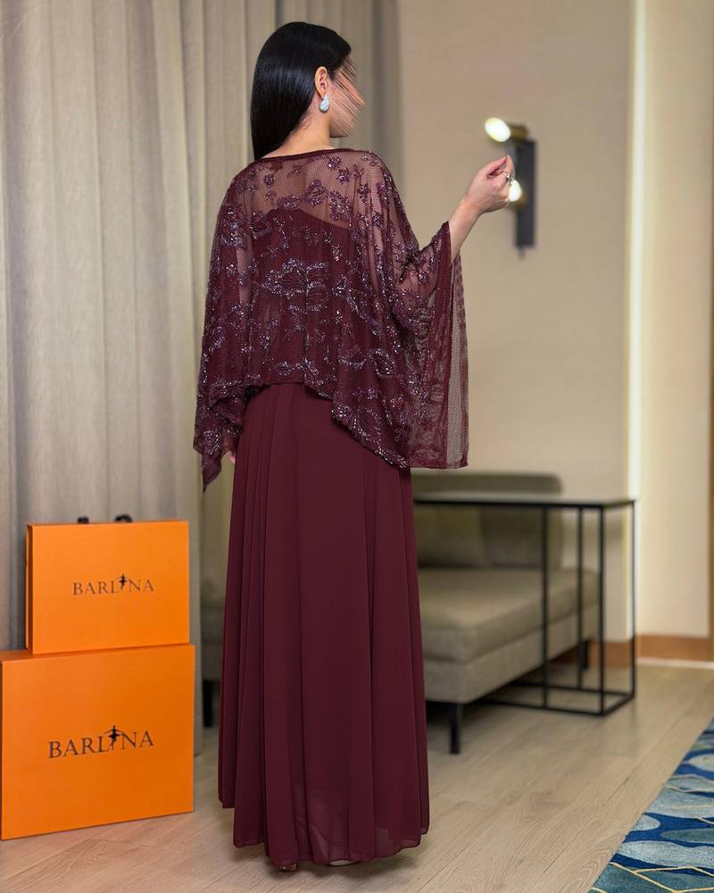 Elegant burgundy dress with a sheer embroidered panel.