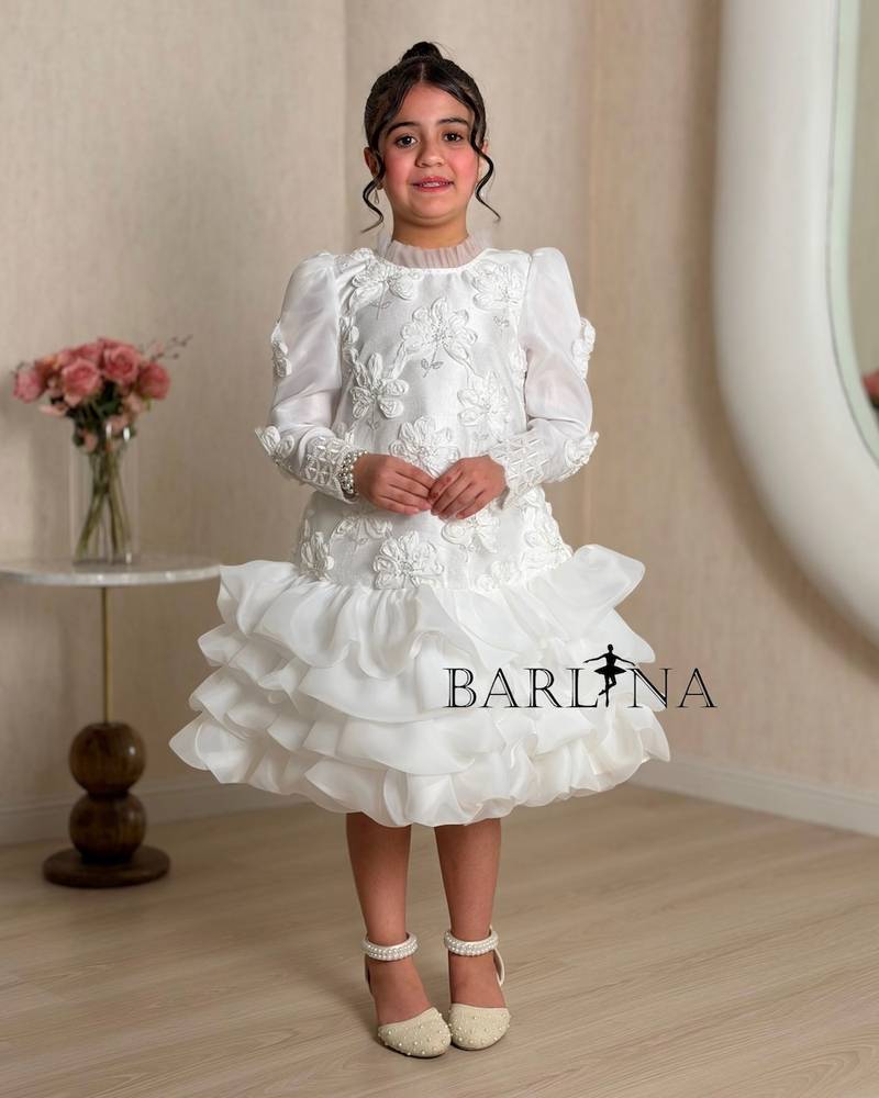 A white girl's dress decorated with raised roses