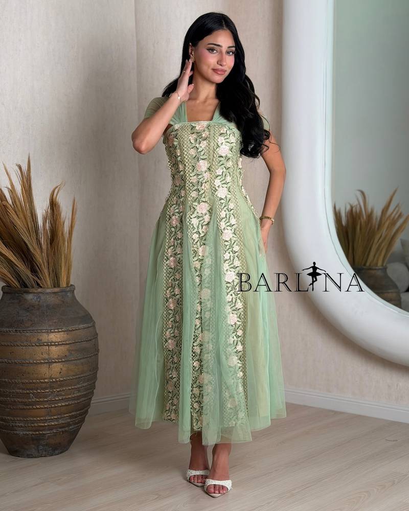 Green dress with tulle sleeves and rose embroidery