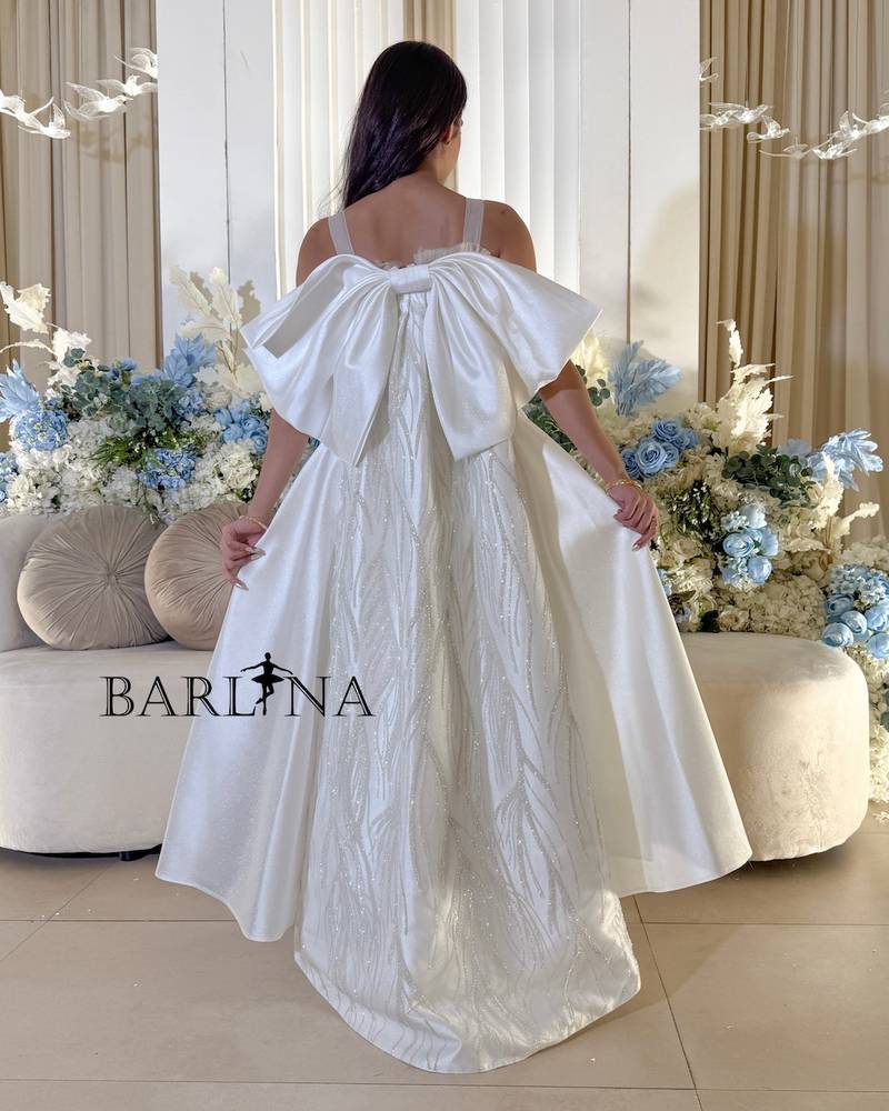 White evening dress with long bow tail