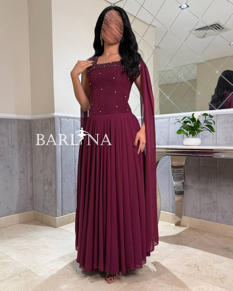 A flowy berry-colored dress with a royal long cape