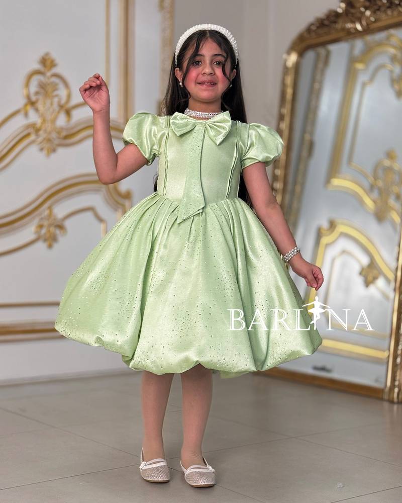Elegant girl's dress with a bow on the chest
