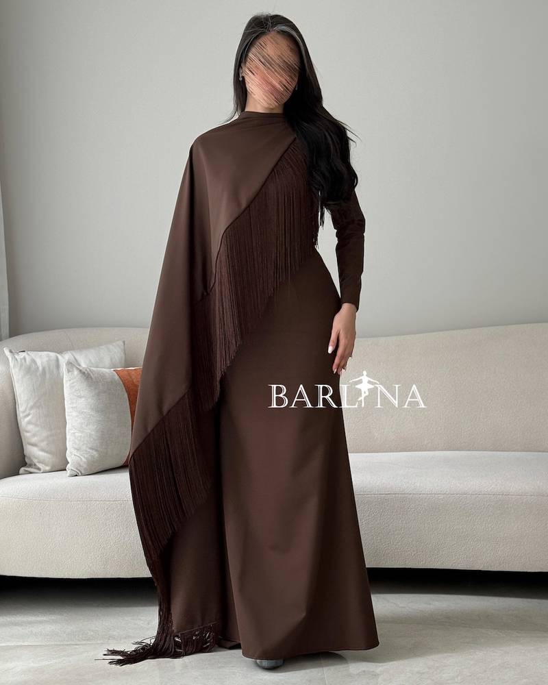 A brown dress with a wrapped cape adorned with fringes