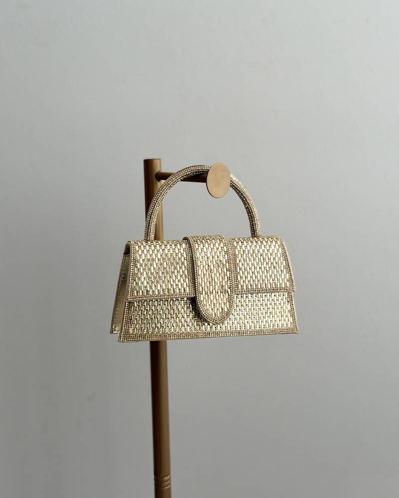 An evening bag completely covered in crystal studs