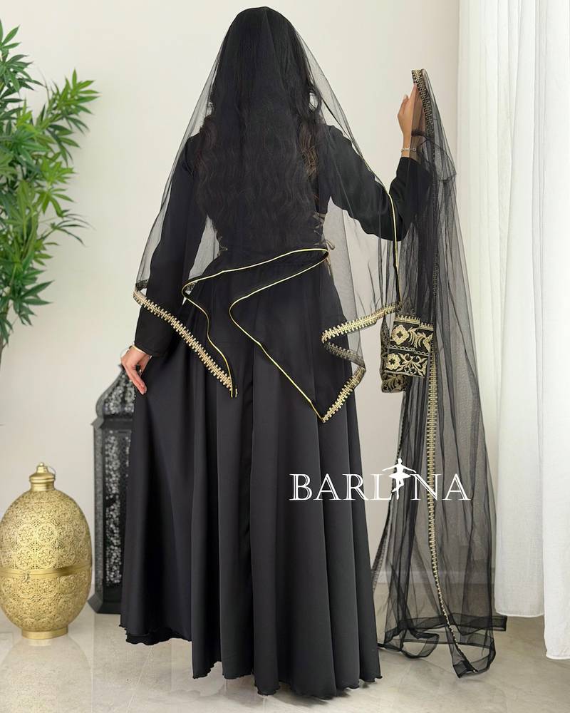 Black jalabiya with gold embroidery and a sheer headscarf