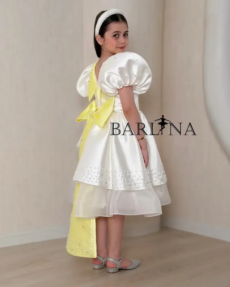 Girls' white evening dress with a yellow touch