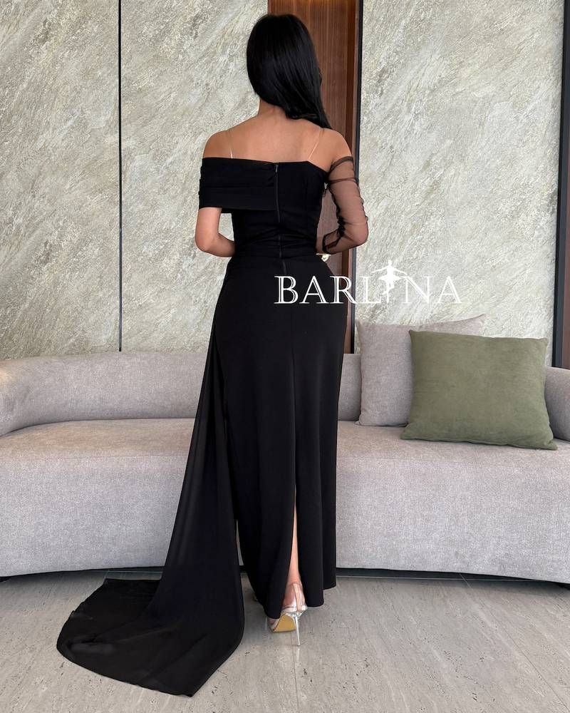 Black off-shoulder dress with a light side train