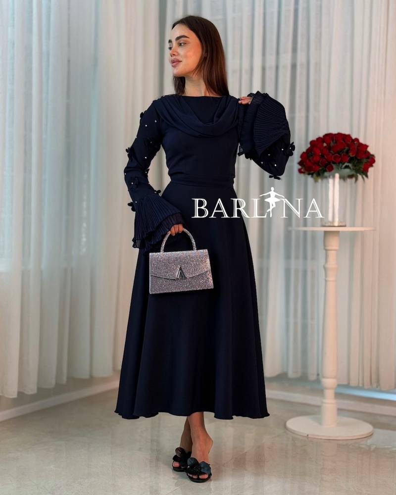 A soft navy dress with a draped collar detail