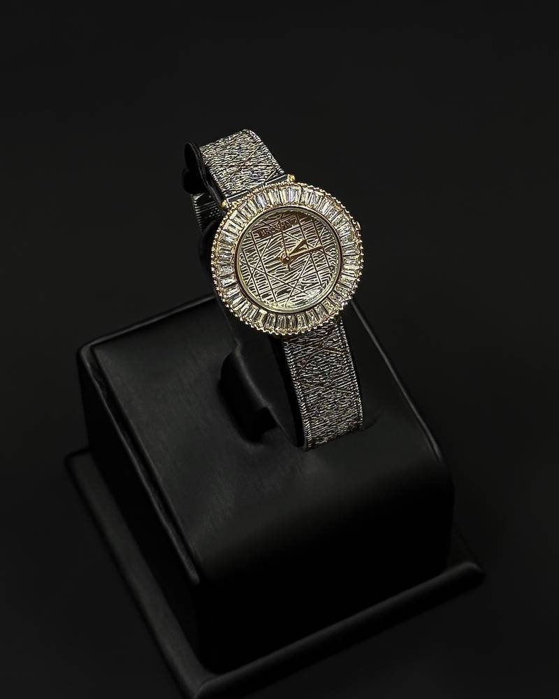 A women's watch adorned with a frame and engraved details